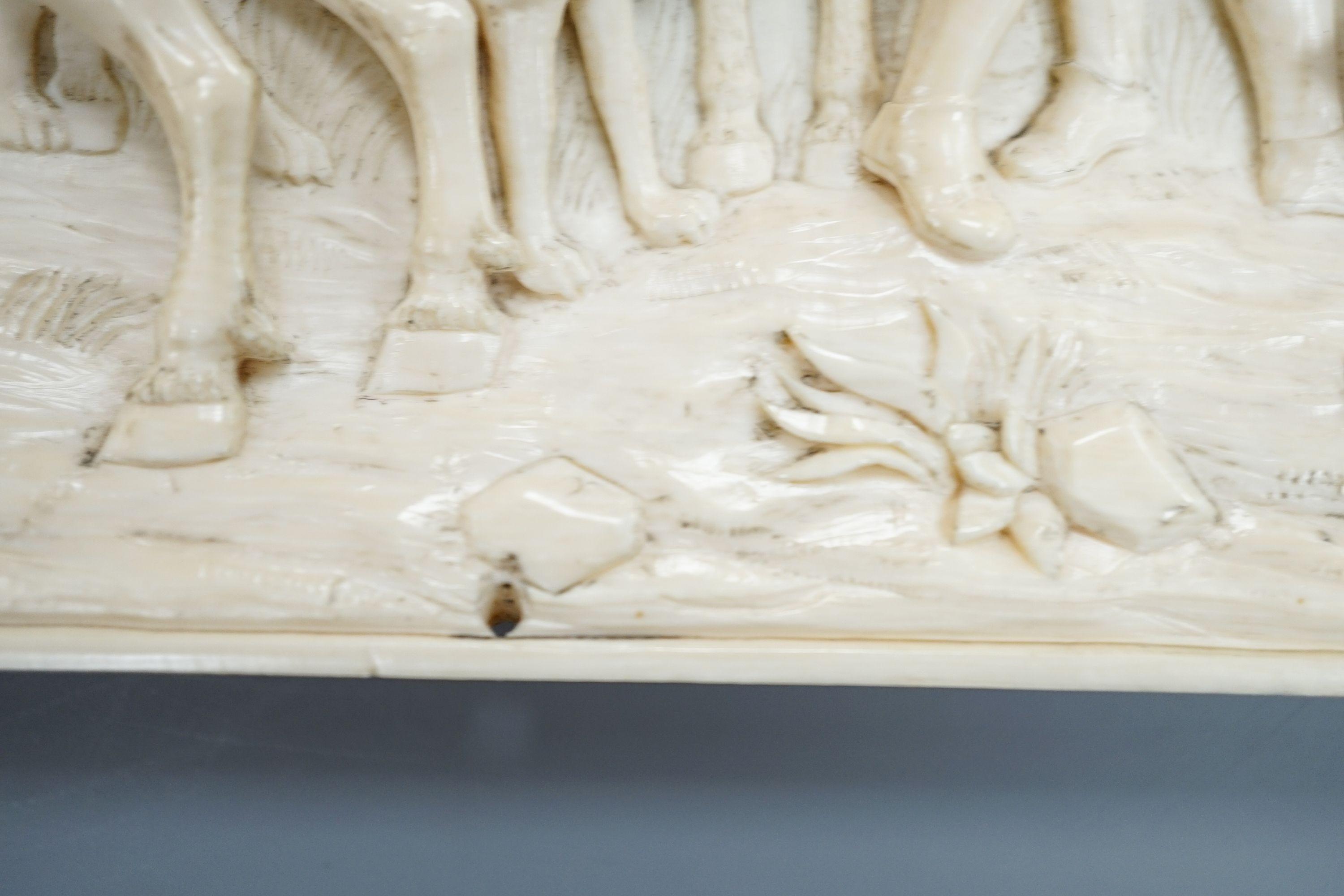 An 18th century Flemish carved ivory plaque (initials OF?) with scenes of hunters and village life, 15 x 28cm